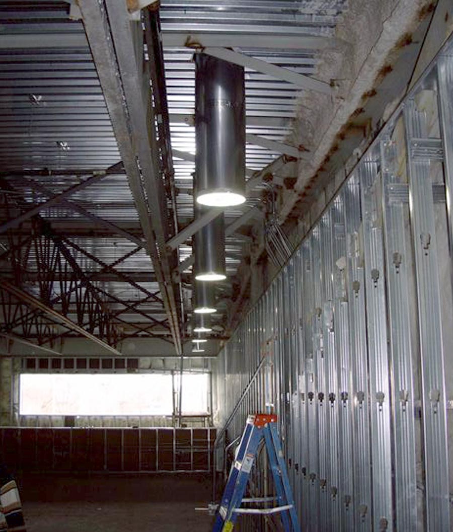 Row of Natural Light suspended ceiling tubular skylights in warehouse